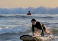 Wisatawan melakukan surfing di Pantai Legian Bali